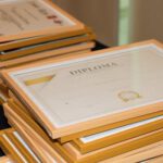 A stack of elegant framed diplomas prepared for an academic ceremony.